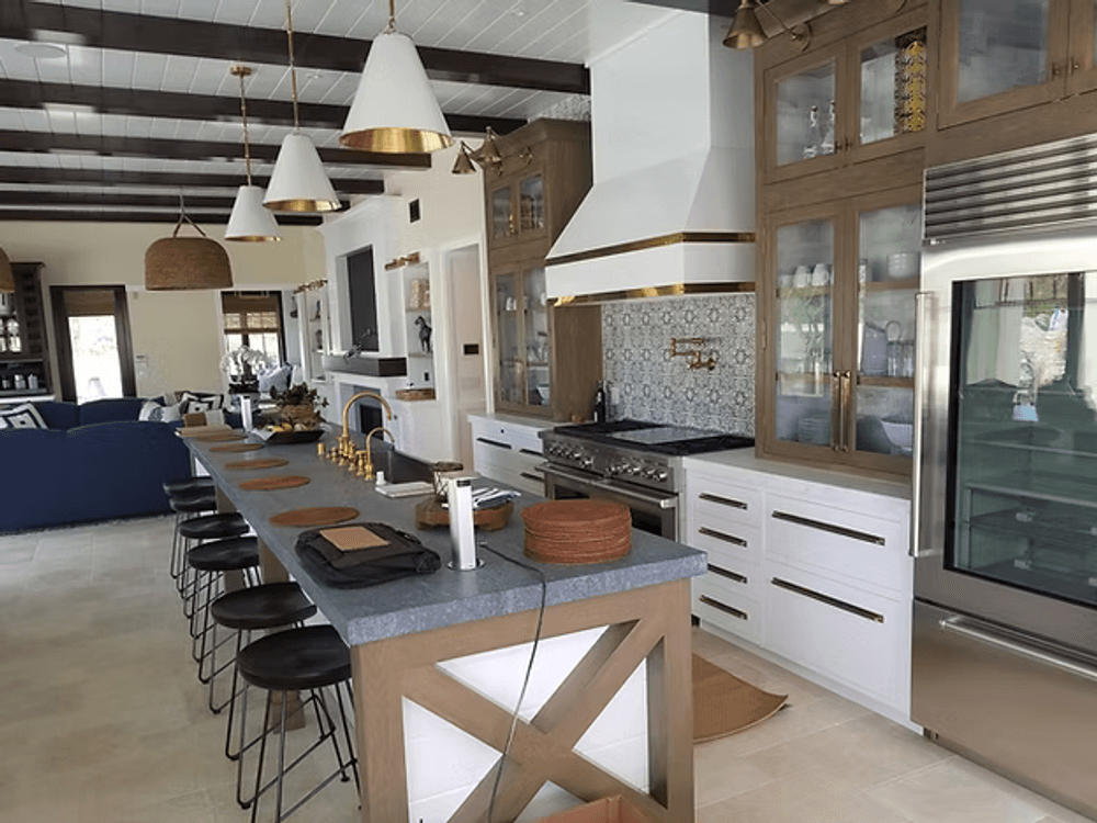 Modern kitchen featuring a large island, sleek appliances, and stylish wood accents.